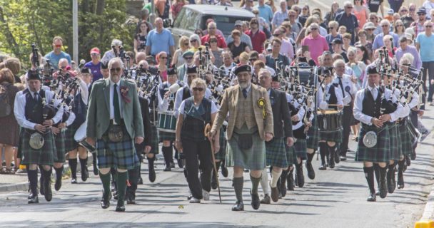 Halkirk Highland Games chieftain, Lord Thurso, (front right) and president Alistair Swanson, (front left), lead the massed pipebands from Thurso and Wick, along with officials and members of the public from the centre of the village to the games field. Photo: Robert MacDonald/Northern Studios